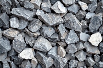 An abstract background gray gravel stones, highlighting the texture crushed stones and construction rocks from a top-down view