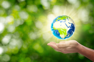 Save Earth. Woman holding glowing globe outdoors, closeup