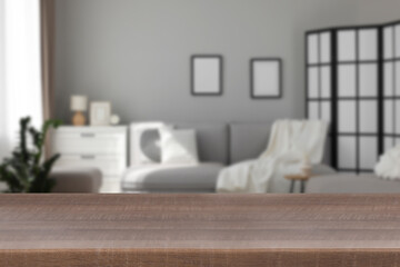 Empty wooden table in beautiful living room. Space for design