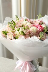 Beautiful bouquet of fresh flowers on table indoors, closeup