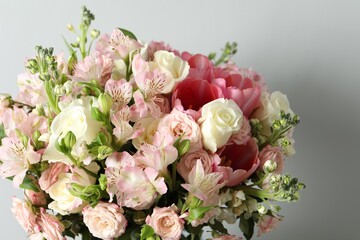 Beautiful bouquet of fresh flowers on light background, closeup