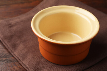 One ceramic casserole on wooden table, closeup