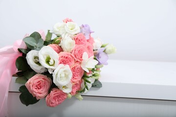 Beautiful wedding bouquet on white table, closeup. Space for text