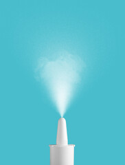 Nasal spray with sprinkled medication over nozzle on light blue background, closeup