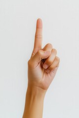 Naklejka premium A hand with a raised index finger, symbolizing a point or a request for attention.