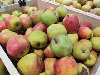 Red ripe apples on display in fruit shops are sold for juice or eaten directly