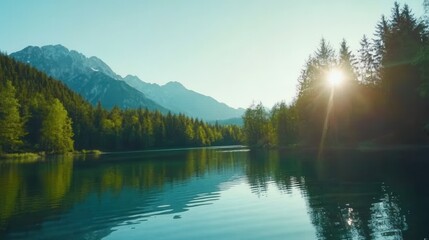 Obraz premium Serene Mountain Lake Under Bright Blue Sky at Sunrise with Reflection