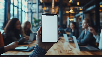 A professional interaction scene highlighting a blank laptop screen in the center of a collaborative workspace