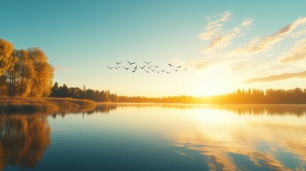 Obraz premium Peaceful Sunrise Over Calm Lake with Flying Birds and Autumn Trees