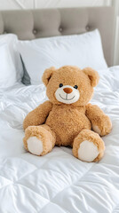 Plush teddy bear sits on a bed in a bedroom, website banner.
