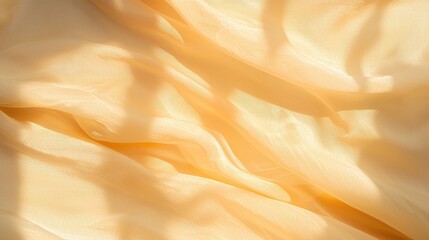 Obraz premium Soft peachhued fabric draped elegantly capturing golden light abstract art indoor setting close-up view texture concept
