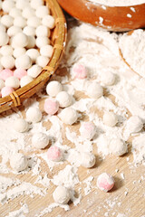 Close up of white and pink rice balls on the wooden table, food closeup    