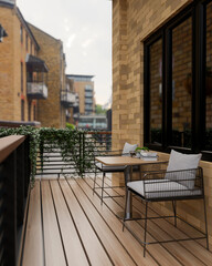 Exterior of a rustic brick outdoor balcony designed for relaxation with a charming rural city view.
