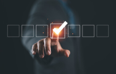 Businessman hand touching to tick correct sign mark on checkbox from checklist , Business selection choice concept.
