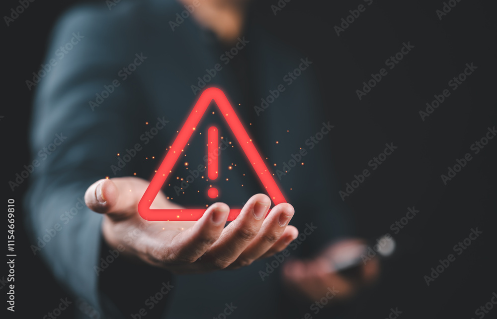 Poster businessman holding glowing red triangle caution warning exclamation sign for notification error and