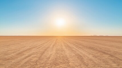 Naklejka premium Vast desert landscape under a bright sun and clear blue sky.
