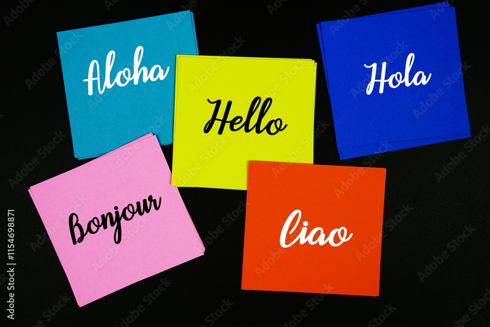 Aufkleber hello in difference language text message on stick note on black background