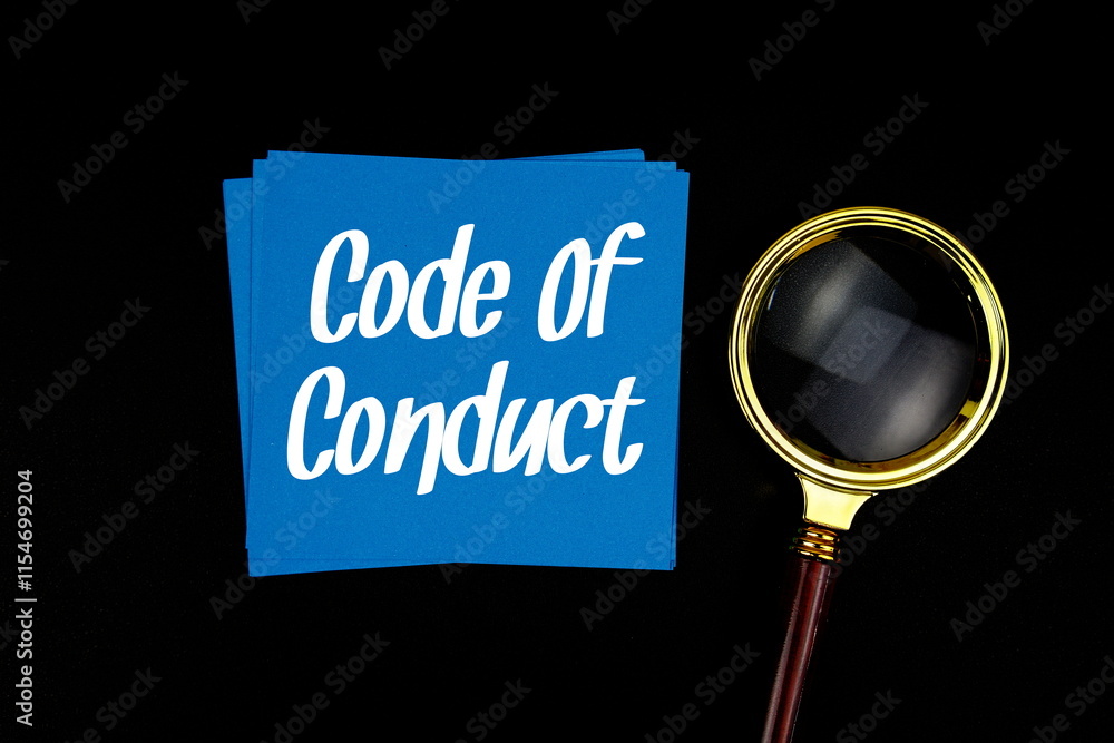 Aufkleber code of conduct text on sticky note with magnifying glass on black background