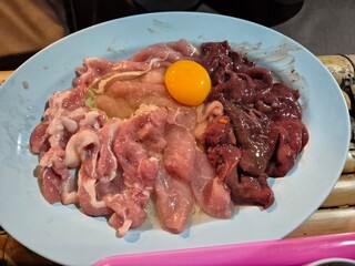 Fresh and raw pork, liver, beef serving on the plate. Famous ingredient in hot pot restaurant. 