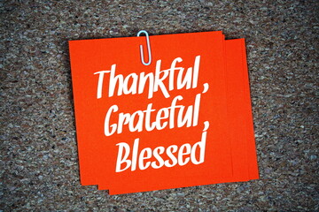Thankful, Grateful, Blessed text message on stick note on cork paper background