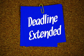 Fototapeta premium Deadline Extended text message on stick note on cork paper background