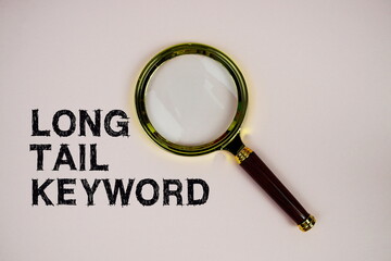 Long Tail Keyword text with magnifying glass on pink background