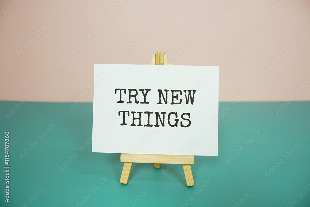 Poster try new things text message on paper card with wooden easel