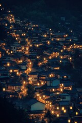 Night view of illuminated houses on a hillside.