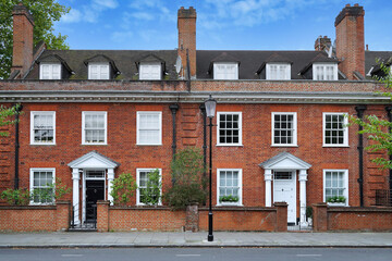 Row of large brick townhouses in London