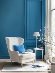 White armchair in a blue room with a lamp and flowers