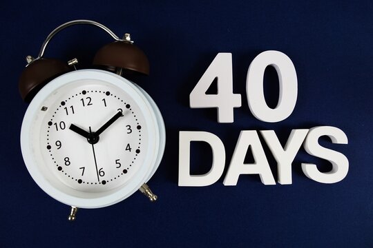 40 Days alphabet letters with alarm clock on navy blue background
