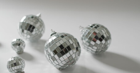 Image of gold confetti falling and silver baubles