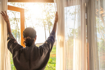 The woman was at the window in the bedroom. She opened the curtains on the window. In the morning...