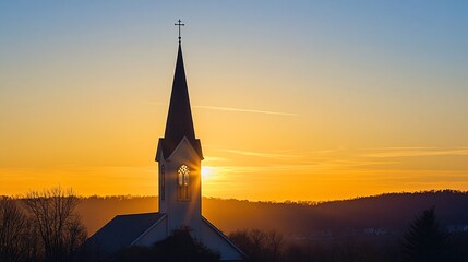 Obraz premium Majestic Sunset Behind a Church Steeple with Clear Sky and Trees