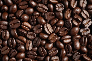 Obraz premium a close up of a pile of coffee beans with a brown background