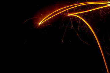 abstract light painting of sparks with negative space