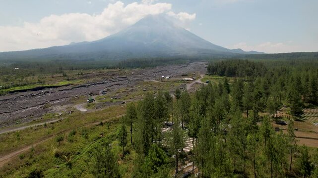 4K Drone Video flying up to view Semaru Volcano, surrounded by green forest landscapes and molton rock in East Java Indonesia