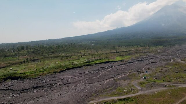 4K Drone Video of Semaru Volcano, surrounded by green forest landscapes and molton rock after a volcano eruption in East Java Indonesia