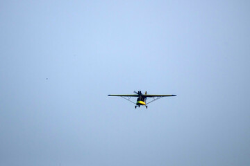 propeller plane is flying on isolated blue sky
