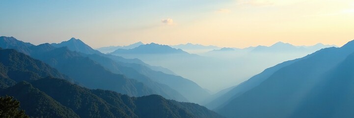 Misty morning over a vast mountain range under clear blue sky, dawn, mountain range, mist