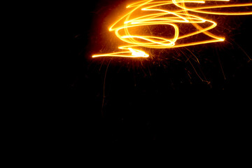 abstract light painting of sparks with negative space