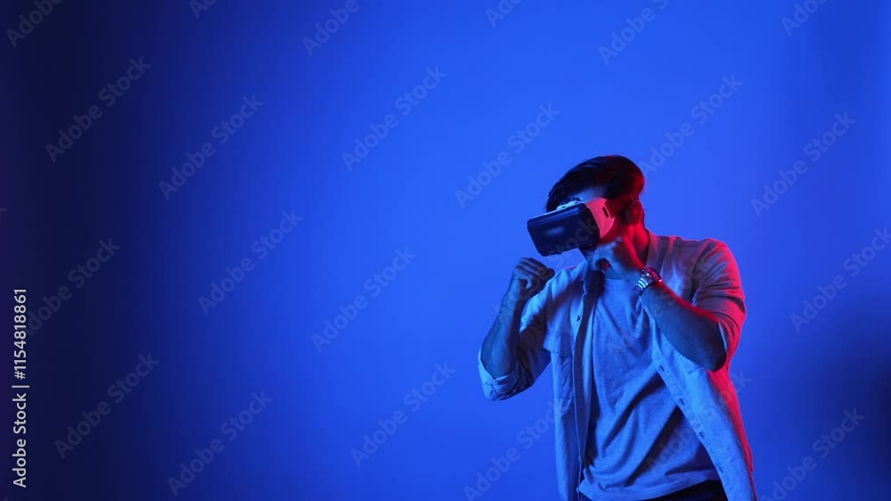 Poster skilled gamer making a punching posture by using virtual reality technology. side view of smart male