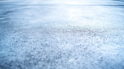 Obraz premium Close-up view of a raw concrete surface featuring a rough texture illuminated by angled light, emphasizing its modern, industrial look ideal for design projects