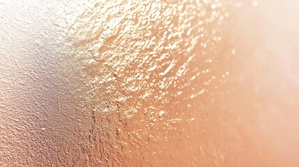 Fototapeta premium Abstract textured background with warm gold and peach hues, showing a bumpy, uneven surface.