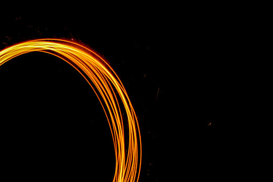 light painting circles of sparks with negative space - Powered by Adobe