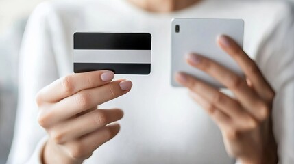 Smiling young woman using a smartphone and credit card for online shopping at home Engaged in mobile banking and internet purchases with ease