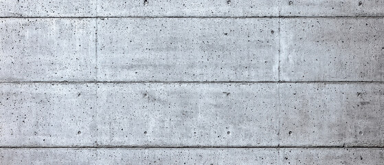 Concrete construction. Concrete wall with a textured surface and horizontal lines.