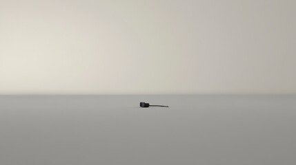 Small black connector lies on a gray surface.