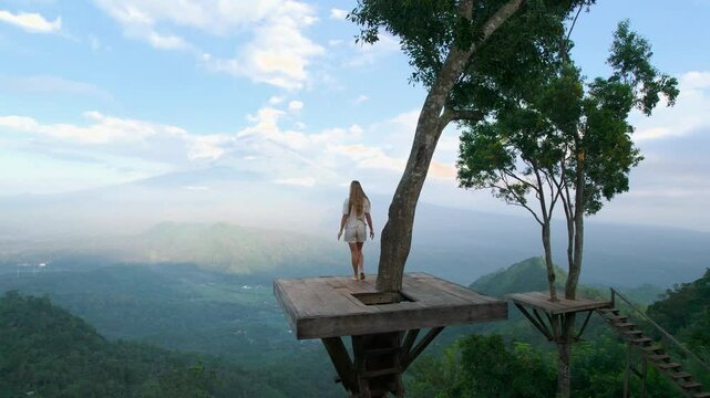 Traveler at viewpoint enjoying the sunrise view of Agung volcano in Bali, Indonesia. Traveling solo, outdoor escape