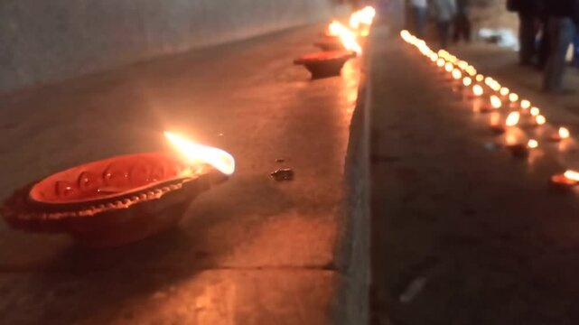 A closeup video of Traditional Indian Lamps or Diyas lighted for Deepavali or Diwali in India